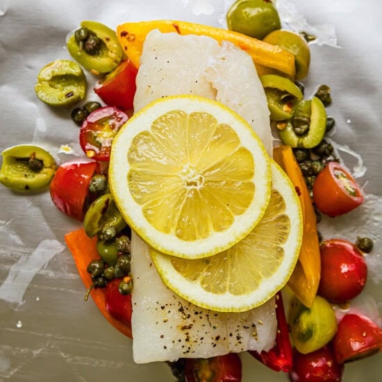 fish, lemons, olives and vegetables in foil