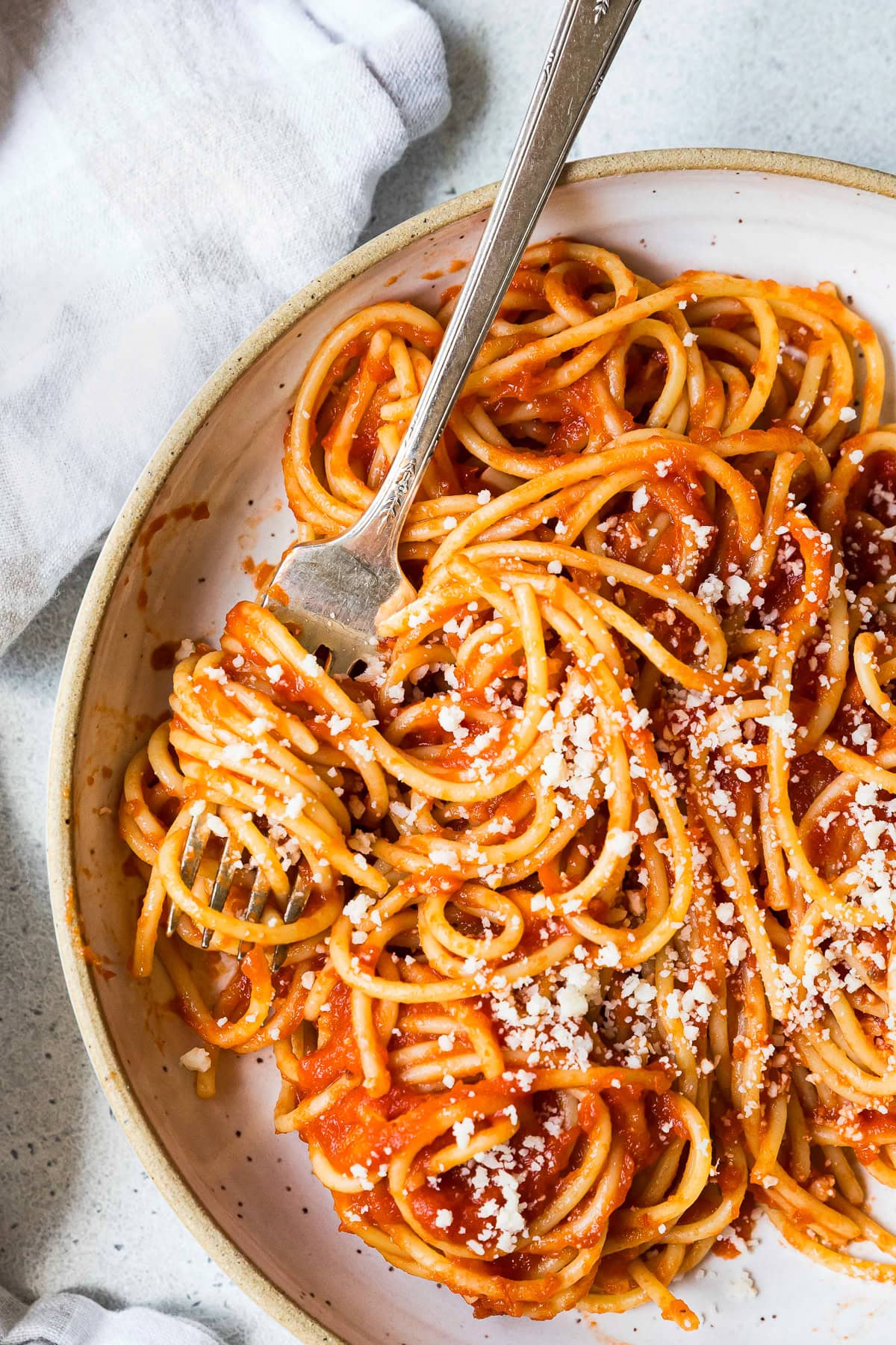 Pasta tossed with light tomato sauce and sprinkled with Parmesan cheese