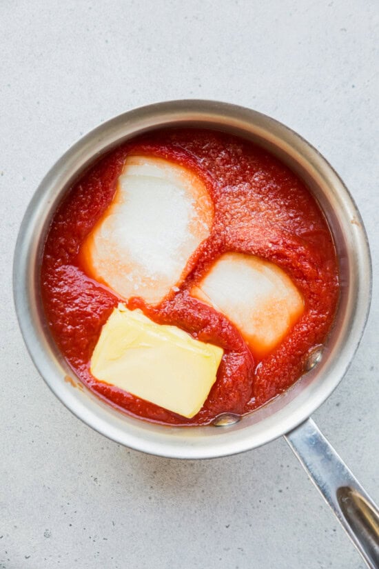 onion, butter and crushed tomatoes in a pot