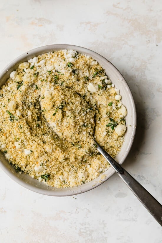 Mix breadcrumbs with grated cheese and herbs