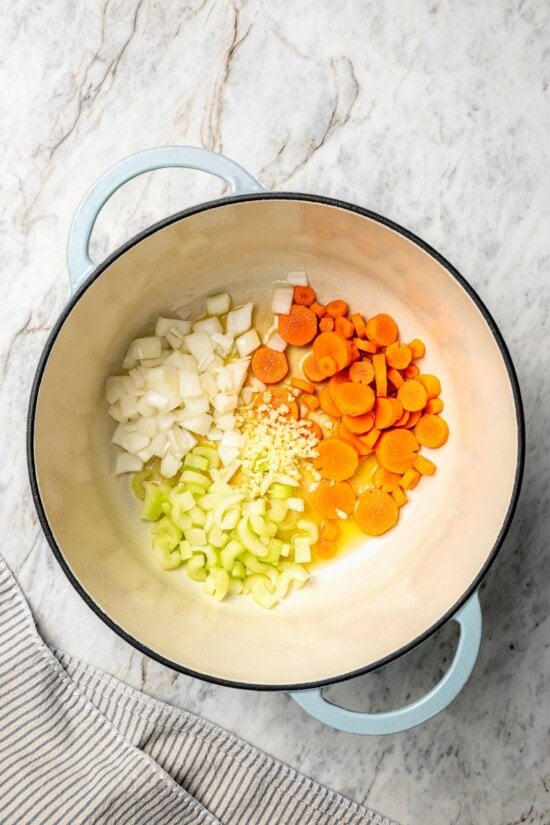 Carrots, celery, onion, and garlic in dutch oven.