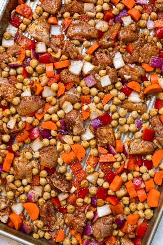 Chicken, vegetables and chickpeas on a baking sheet