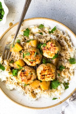 Hawaiian Chicken Meatballs with Pineapple Coconut Sauce over rice