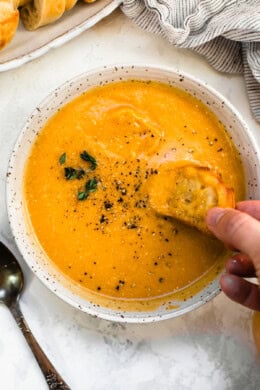 Butternut Squash Cheddar Soup in a bowl with bread