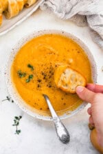 Butternut Squash Cheddar Soup in a bowl with bread