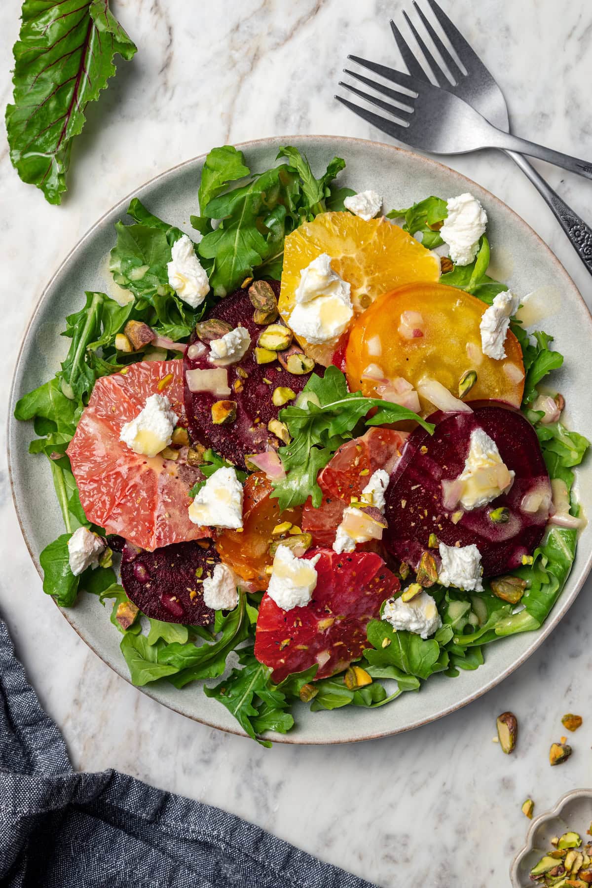 Roasted beet salad with citrus fruit, goat cheese, and pistachios.