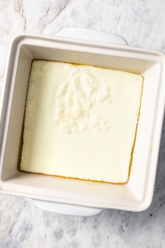 This Chick-Fil-A Egg White Grill copycat is made with juicy grilled chicken, fluffy egg whites and cheese for a hearty meal prep breakfast! Baked egg white omelet in pan.