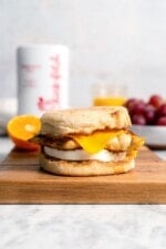 Copycat Chick-fil-A egg white grill sandwich on wood cutting board.