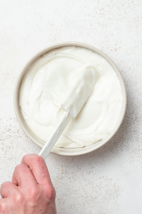 Spreading Whipped Feta Dip on a plate